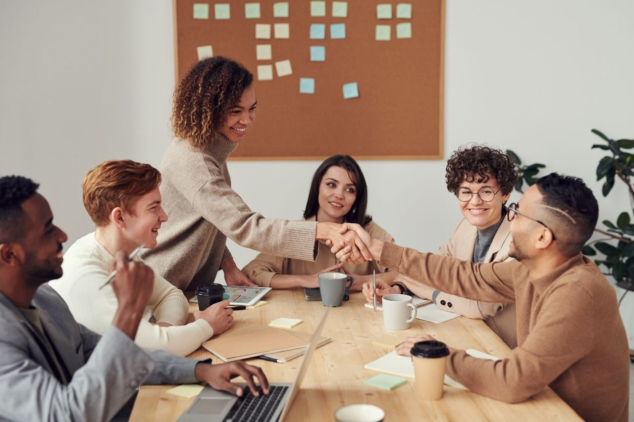 Diverse team smiling together after a successful hire